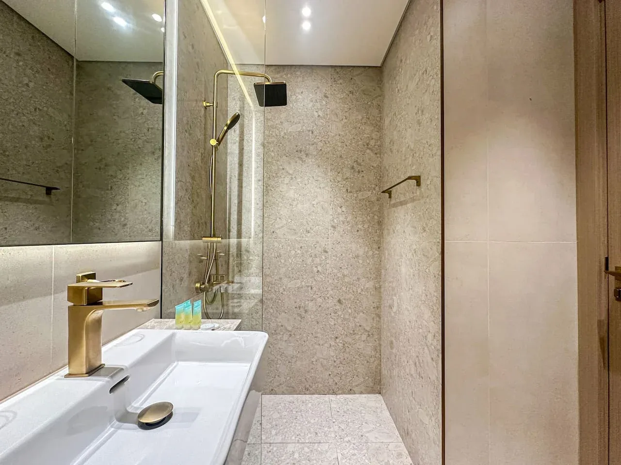 A modern bathroom with a sink and shower area.