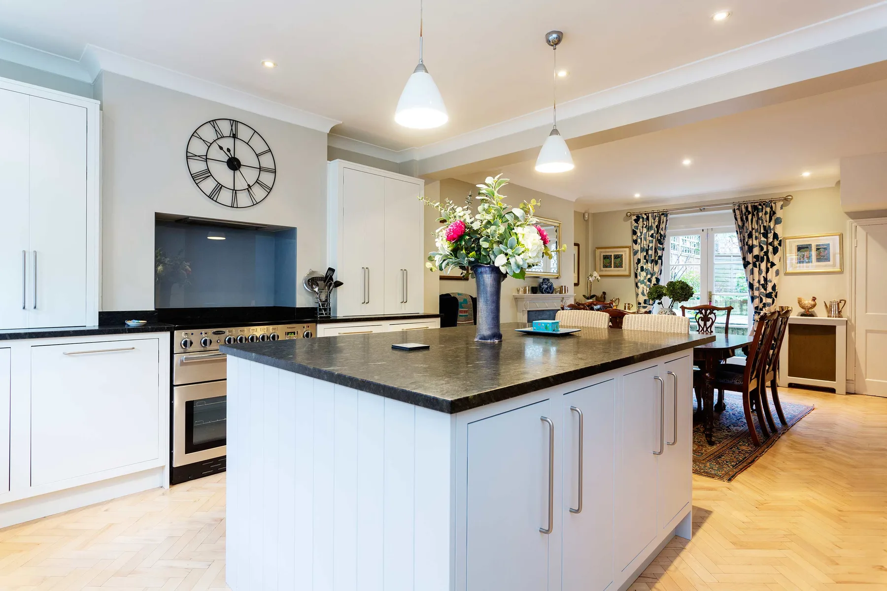 A bright kitchen with a central island and an adjoining dining area.