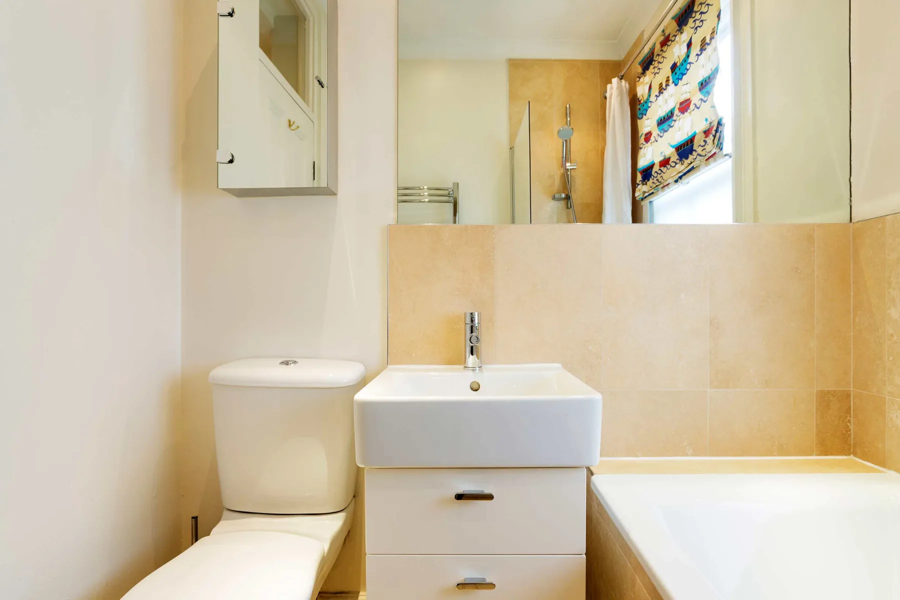 A bathroom with a sink, toilet, and bathtub.