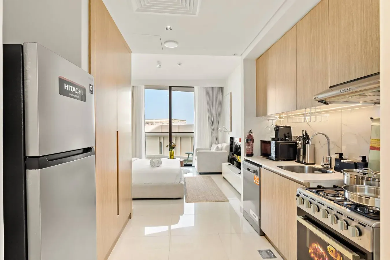 A bright open-plan kitchen and living area opens onto a balcony.