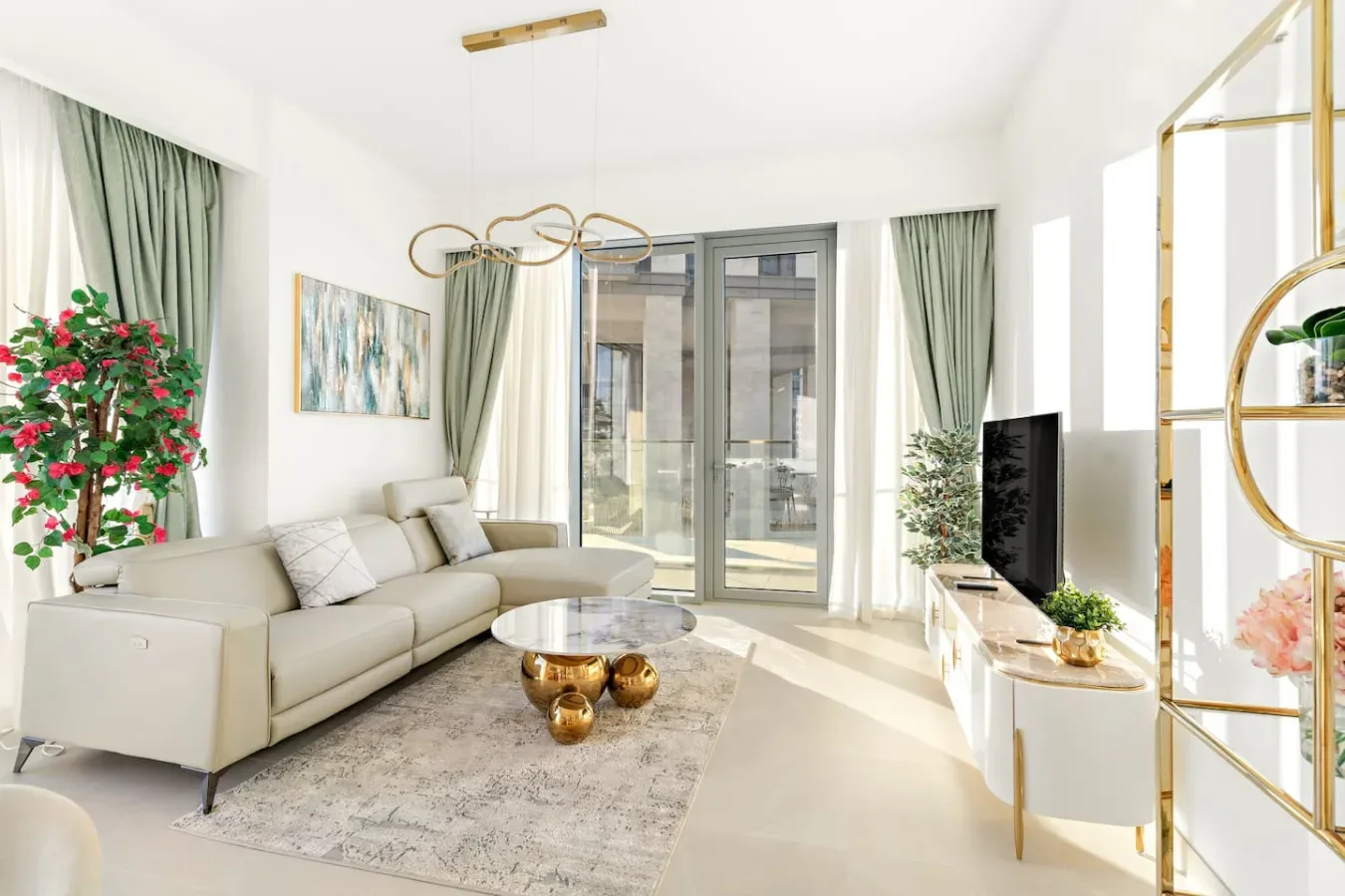 A bright living room with seating, a coffee table, and glass doors.