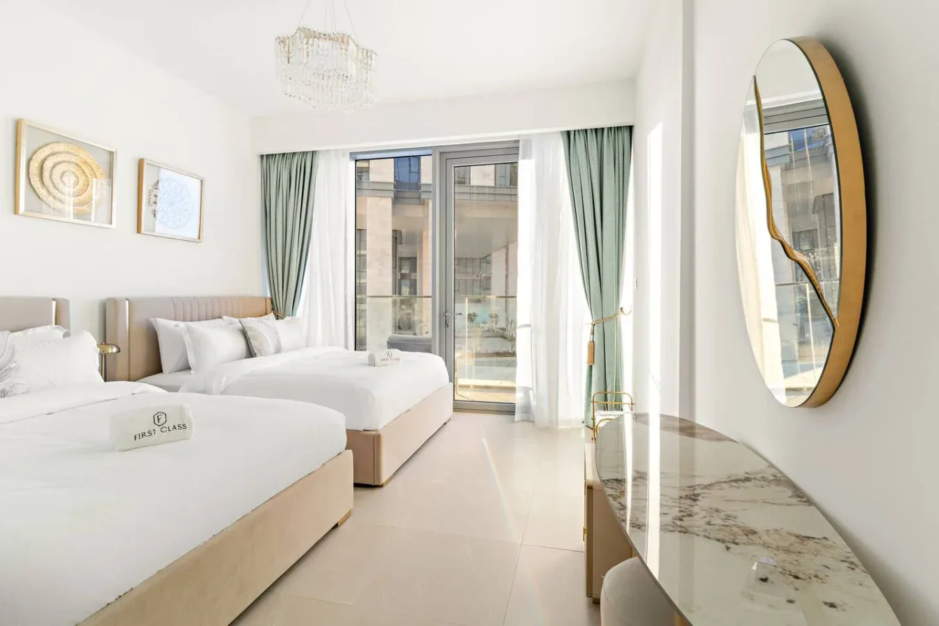 A bright bedroom with two beds, pale curtains, and a large window.