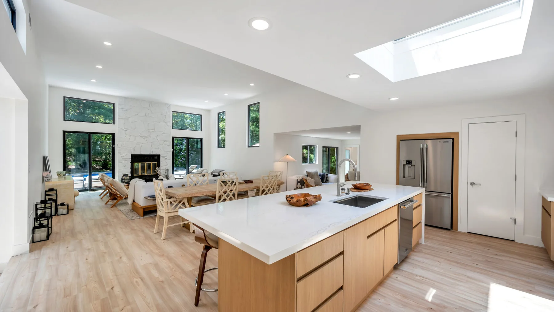 A bright open-plan kitchen and living area with a large central island.