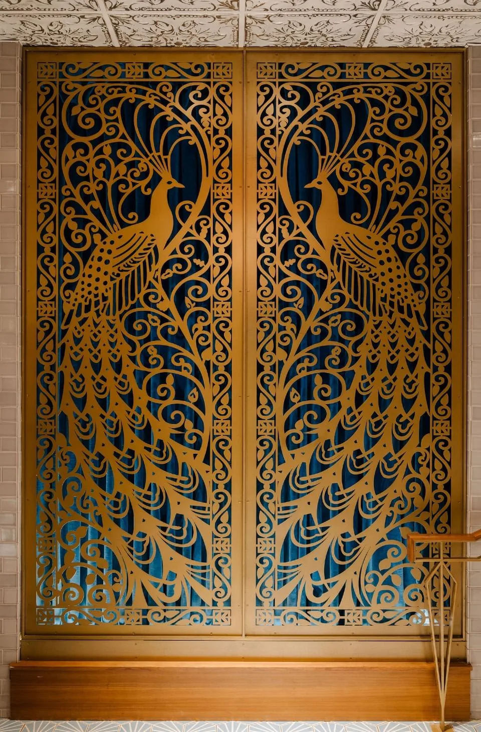 Gold peacock-patterned screen at Hotel Bijou