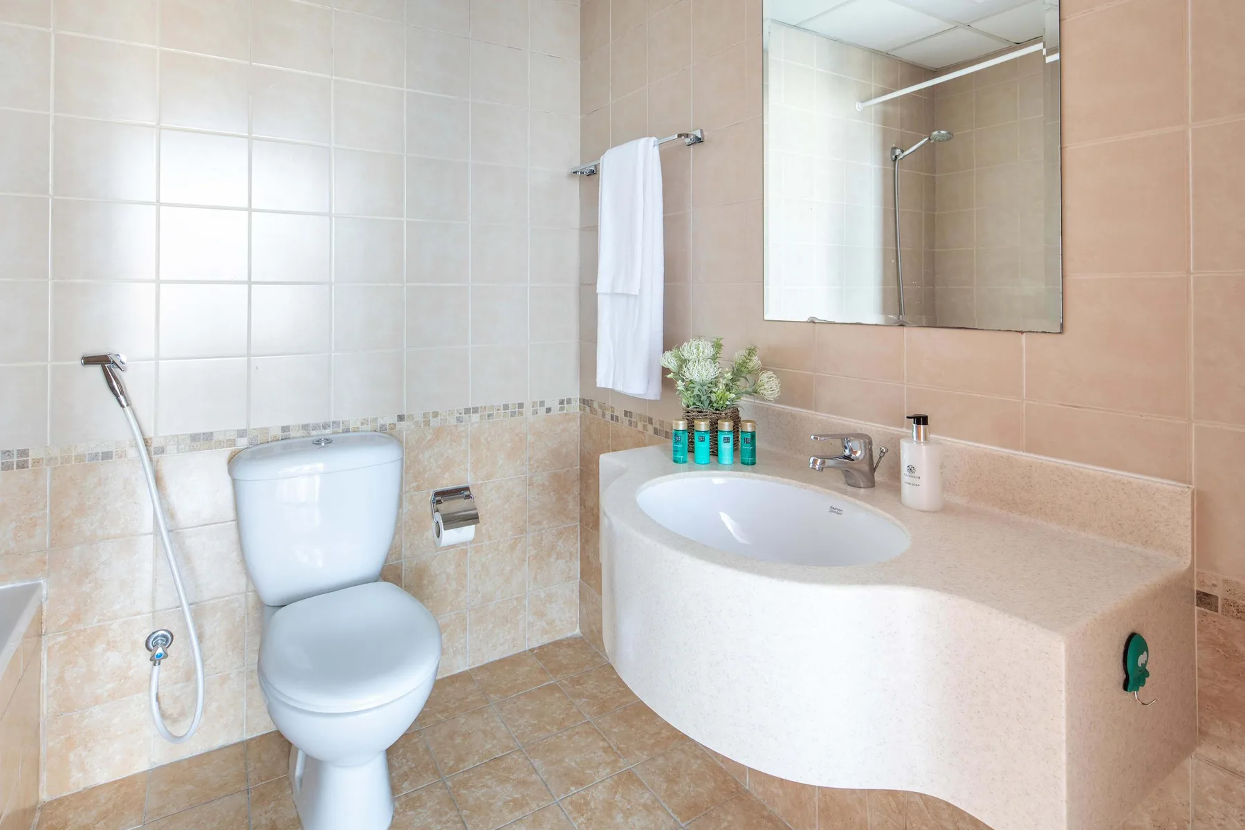 A bathroom with a toilet, a sink, and a bathtub.
