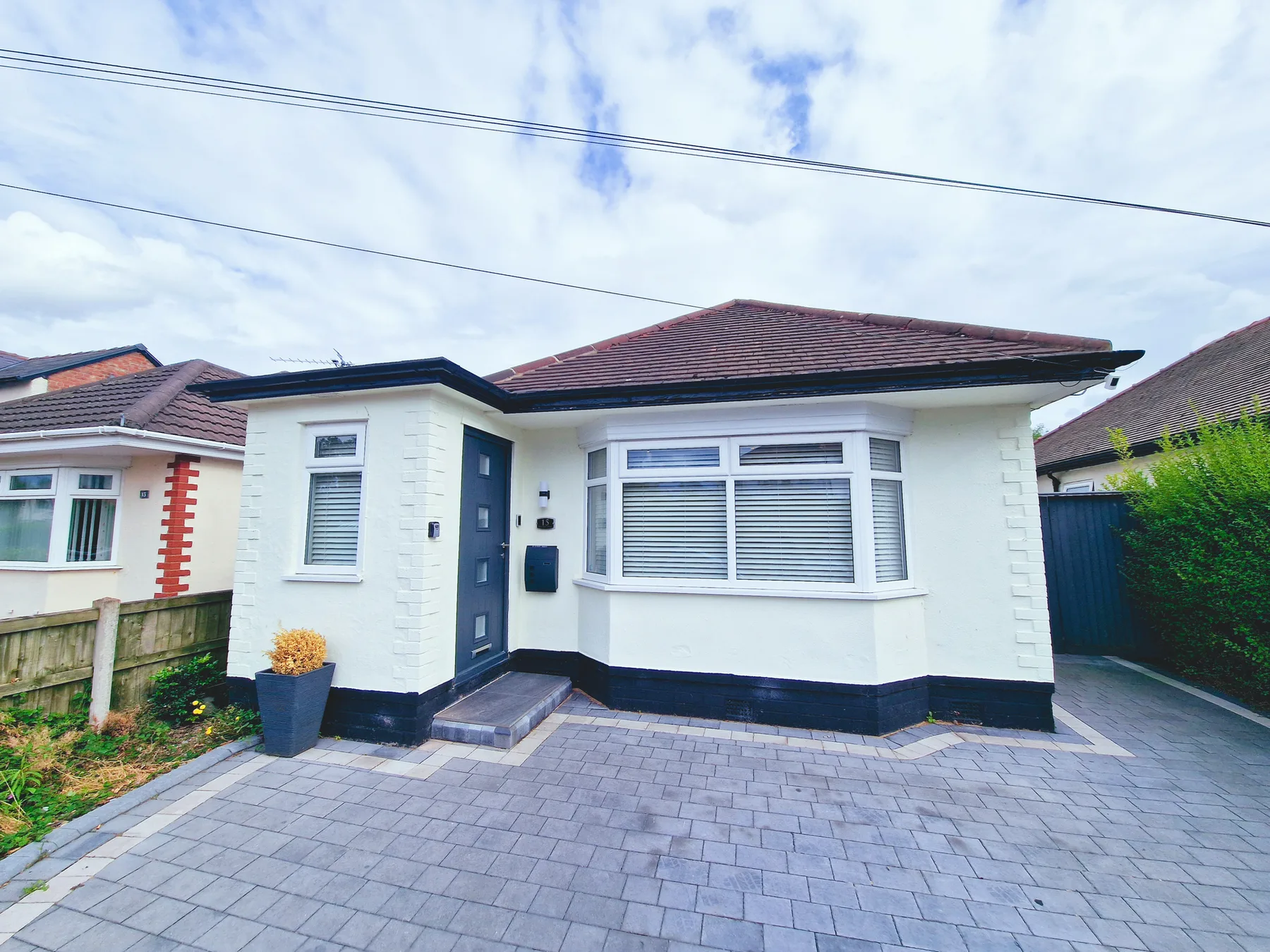 A single-story house with a paved driveway and front garden.