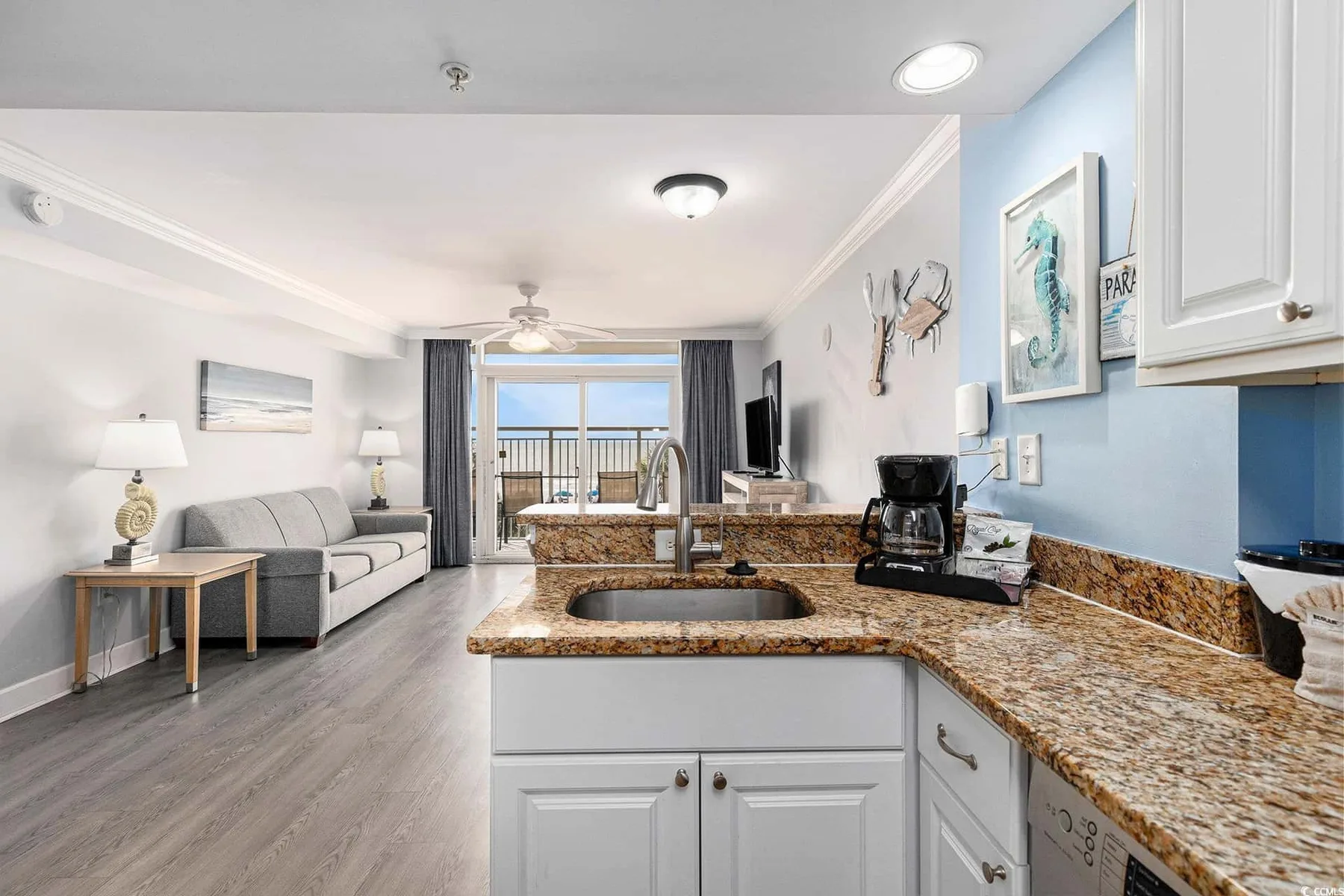 An open-plan living room and kitchen with a counter and seating area.
