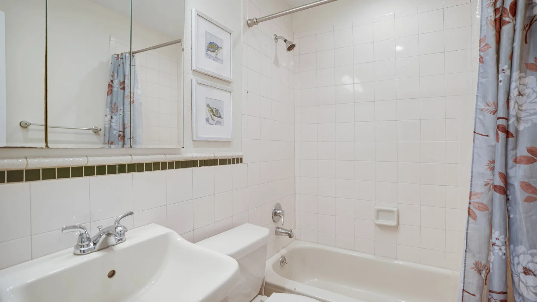 A tiled bathroom with a bathtub, shower, and sink.