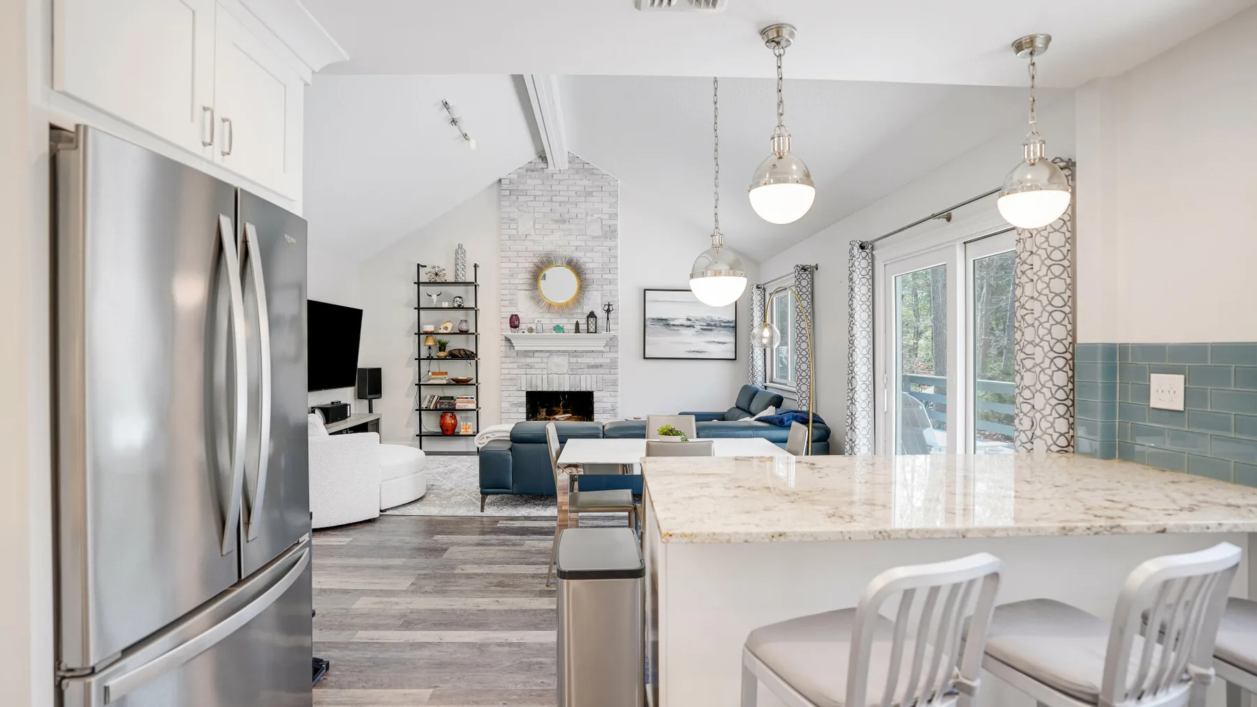 An open-plan kitchen and living area with a large island and seating.