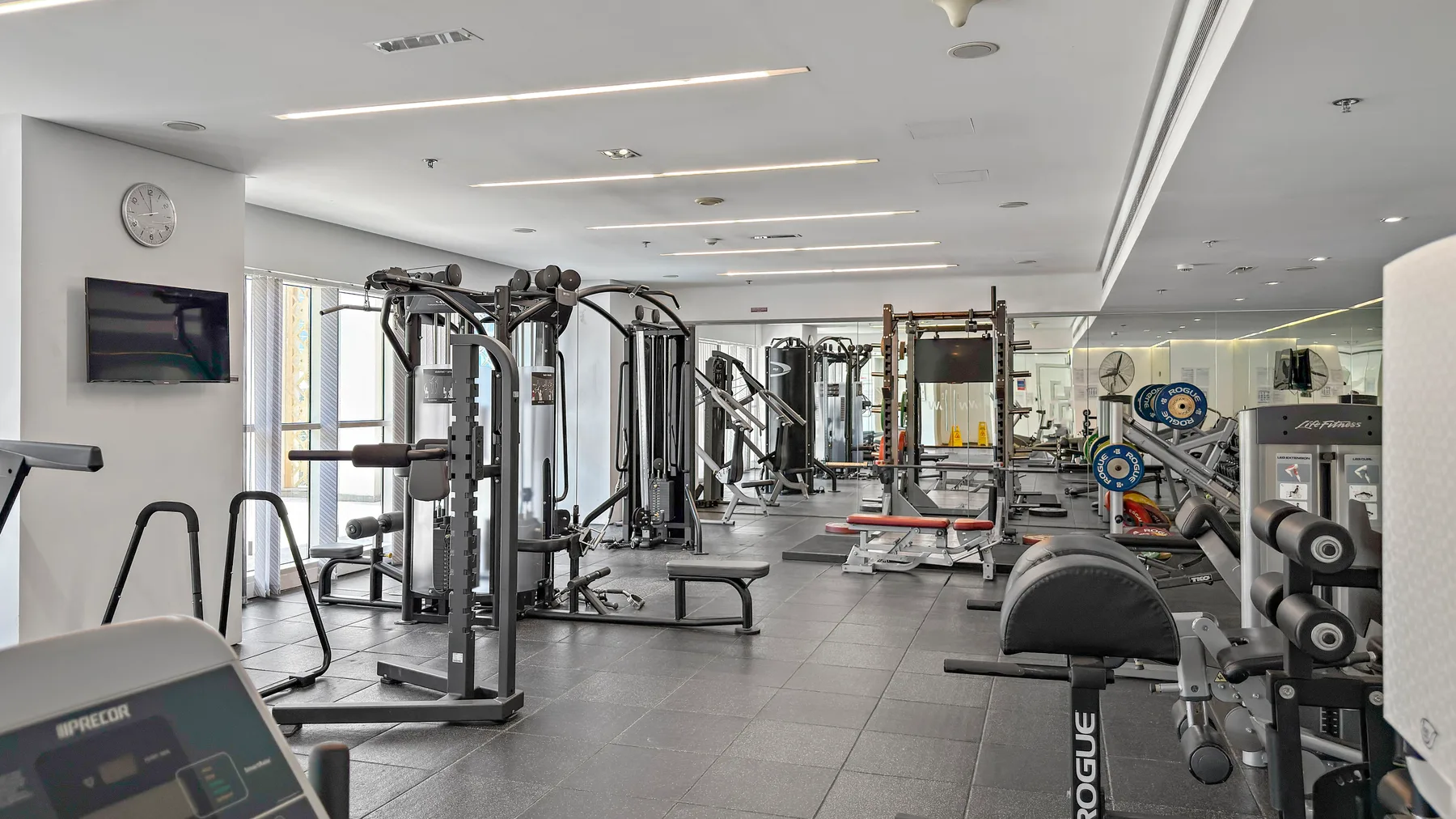 A gym filled with workout machines and weight equipment.