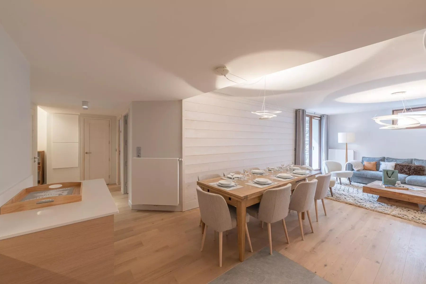 An open dining and living area with a wooden table and seating.