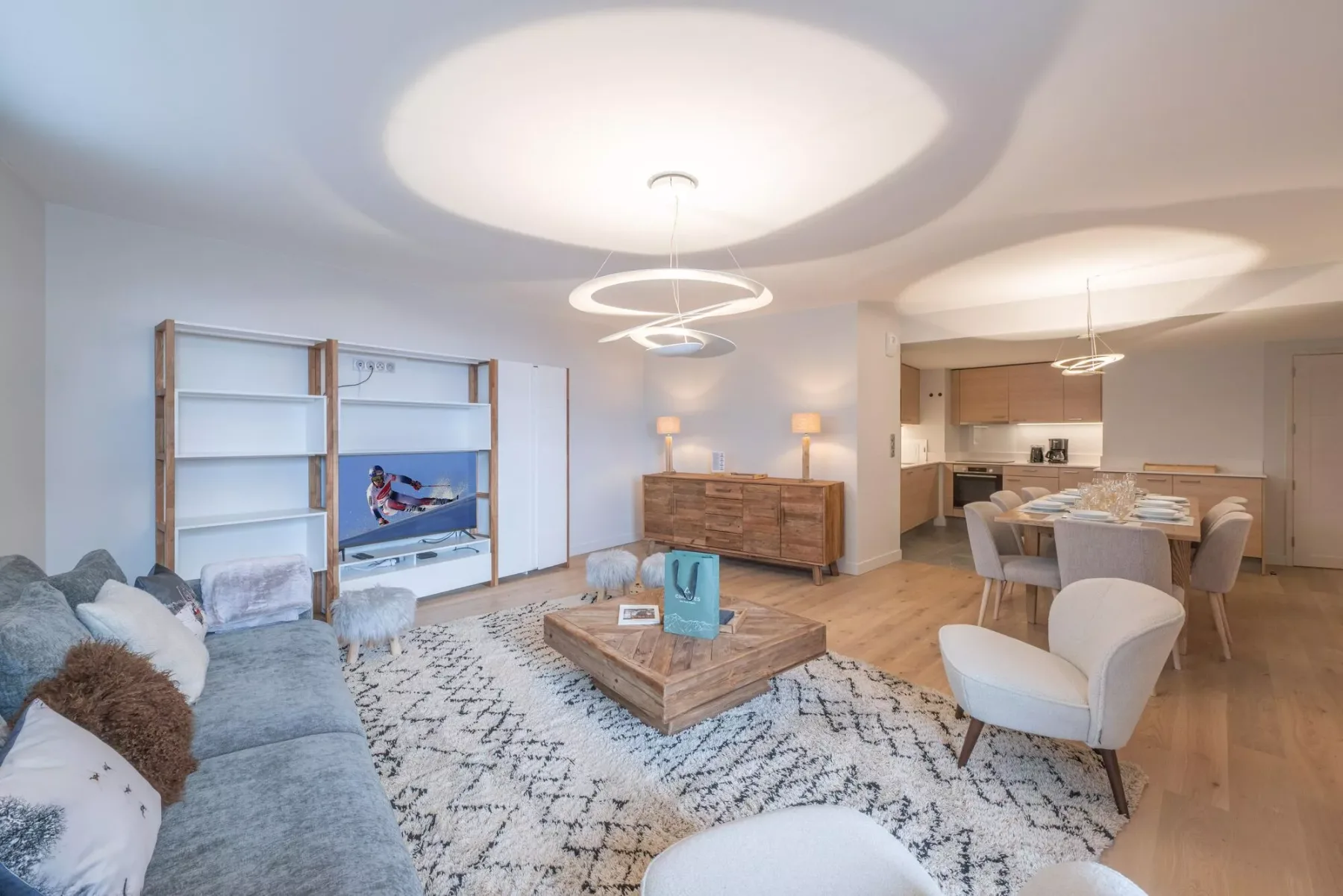 Open-plan living and dining area with a sofa, coffee table, and dining table.