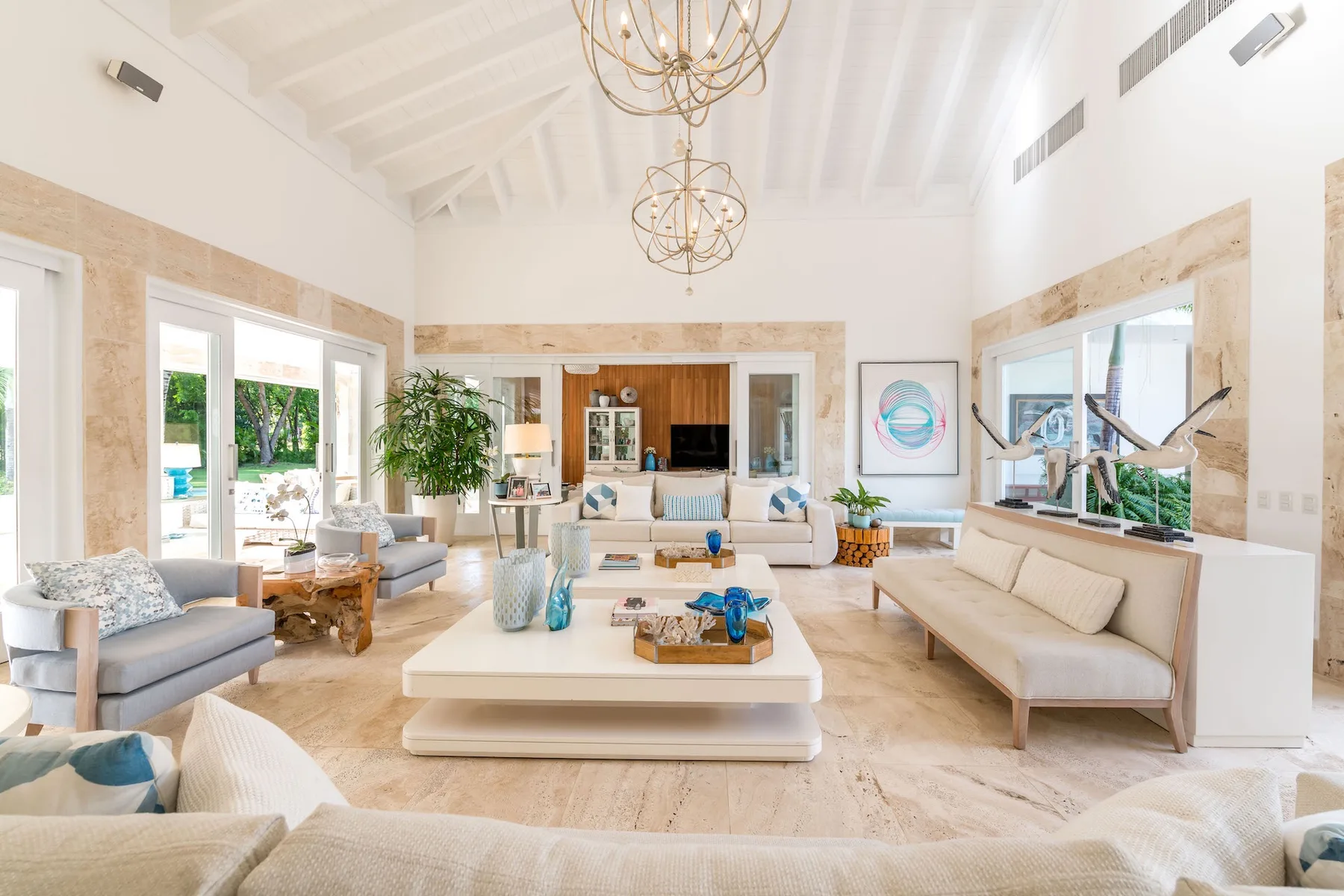 A bright living room with seating arranged around a low central table.