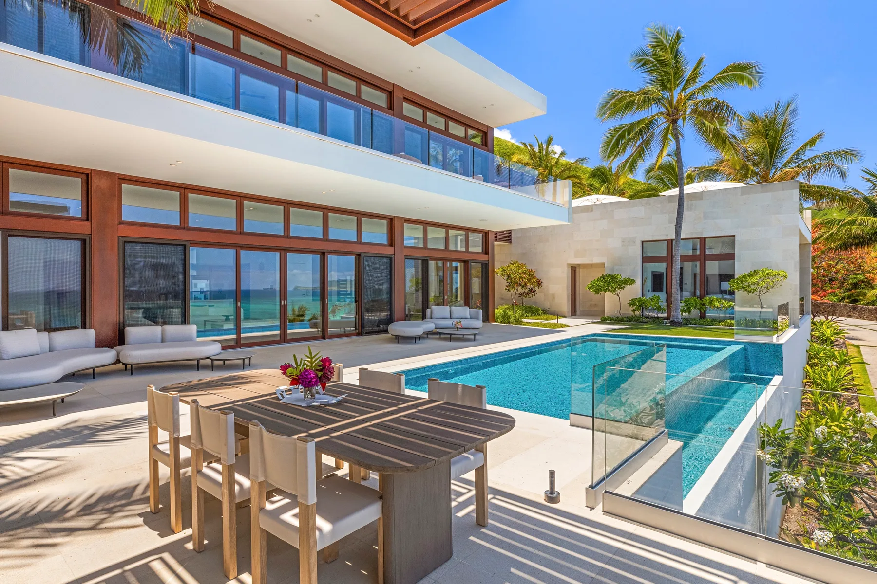 A modern house with a swimming pool and outdoor dining area.