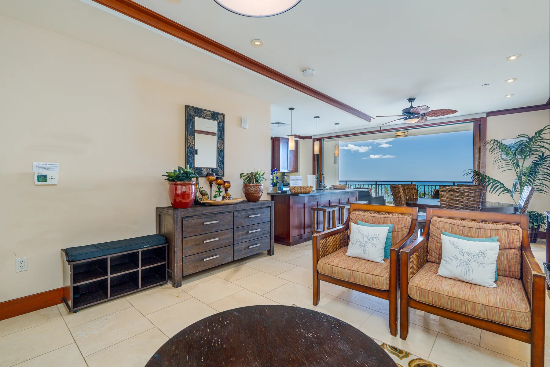 A bright living area with cushioned seating and a wide ocean view.
