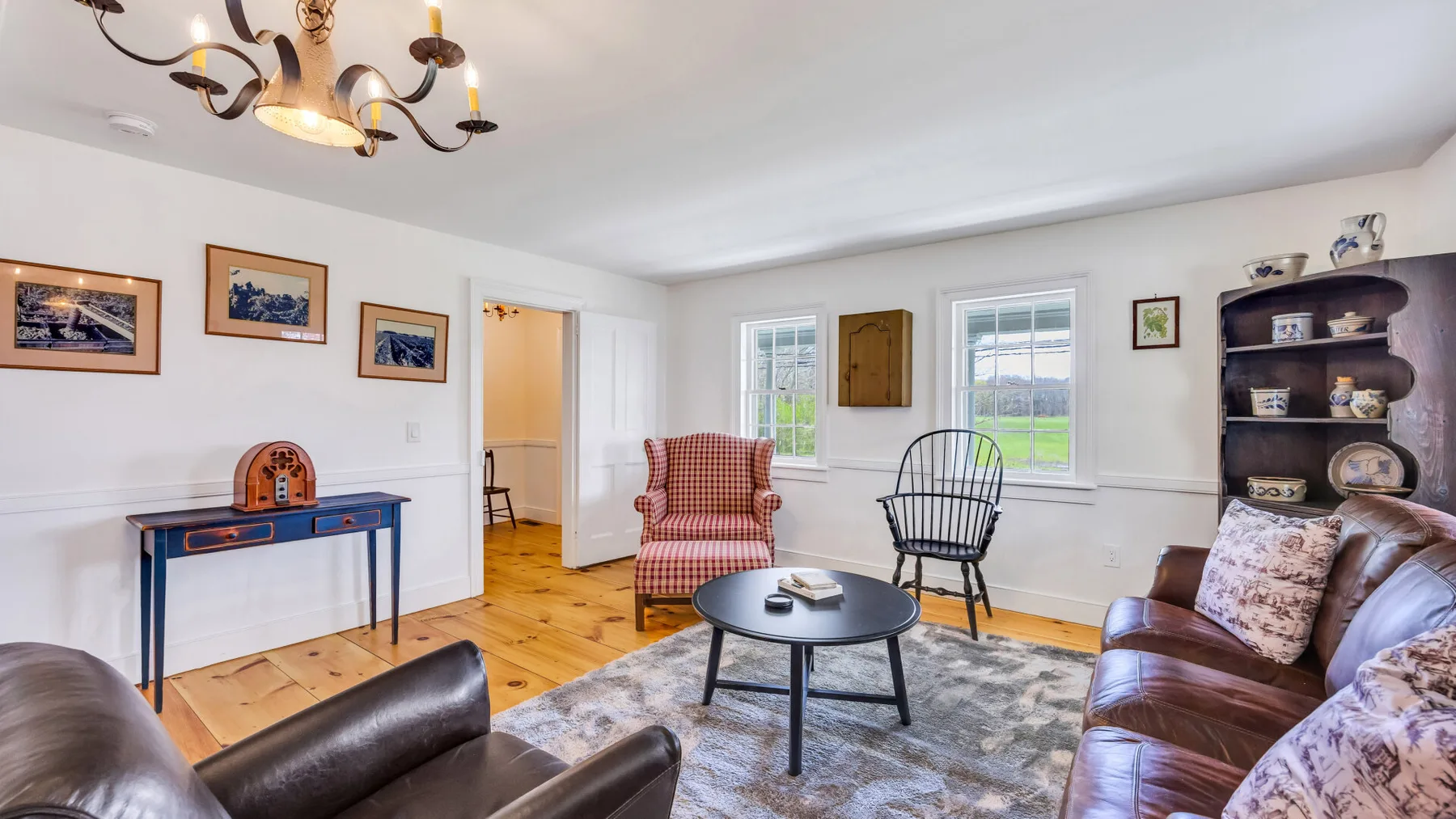 A bright living room with seating around a low coffee table.