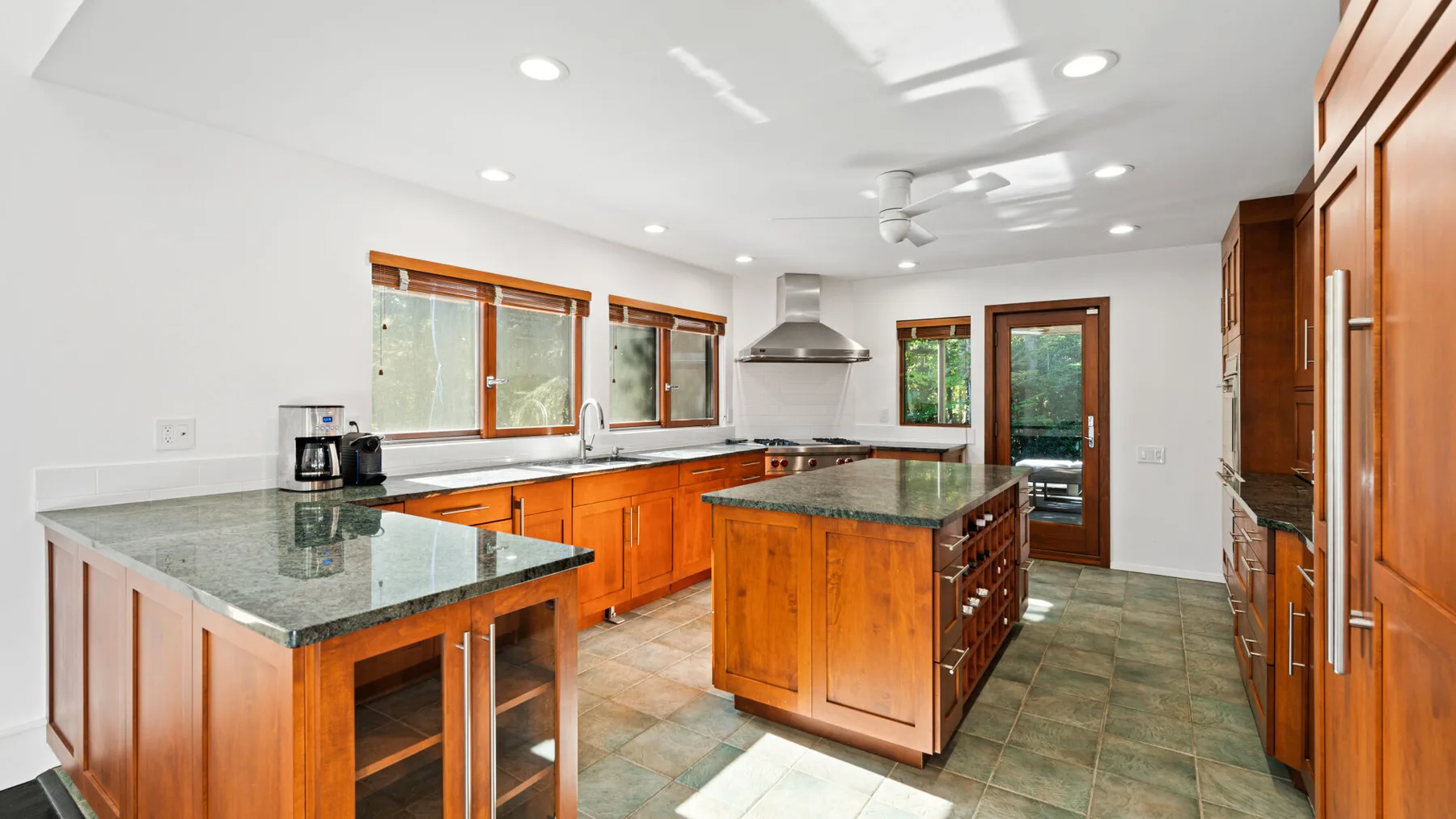 A spacious kitchen with wooden cabinets and a central island.