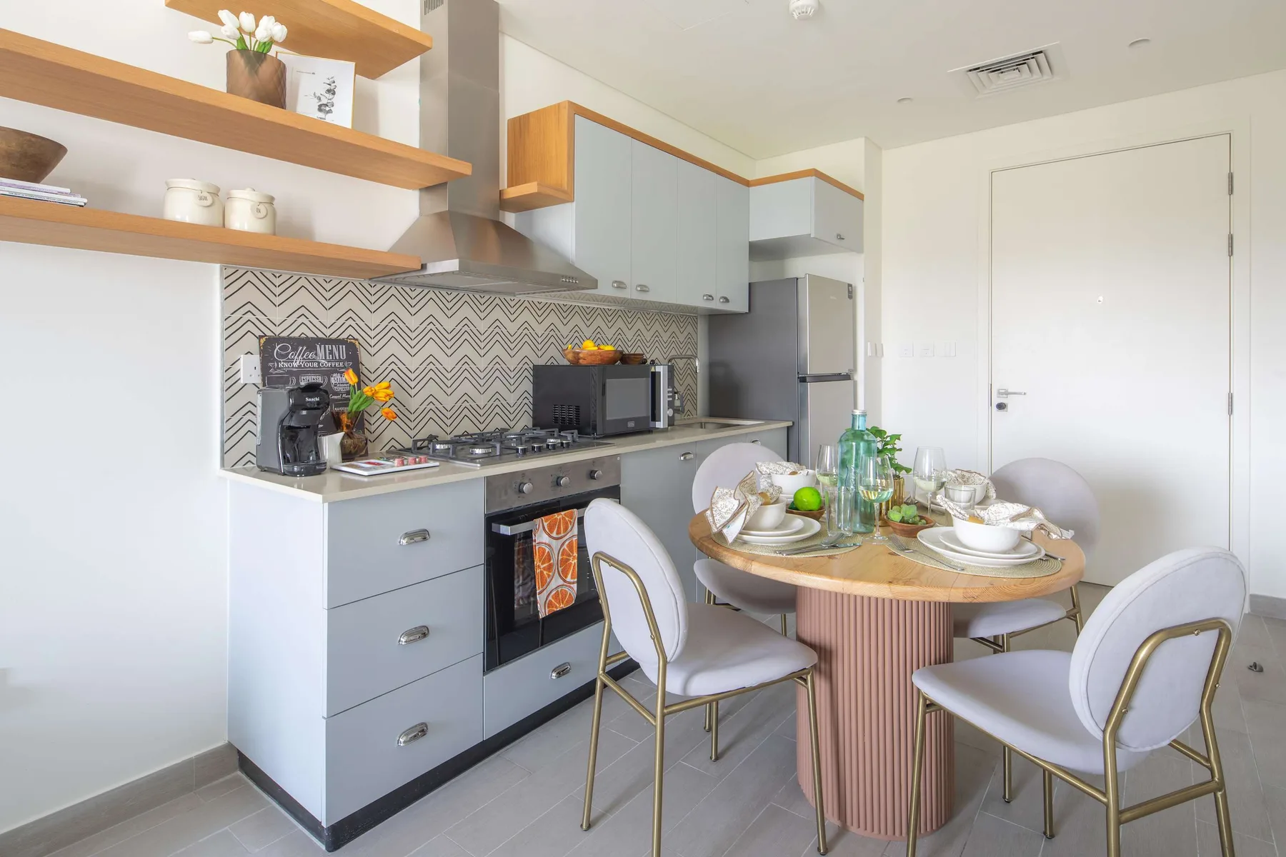 Una cocina compacta y zona de comedor con la mesa preparada para comer.