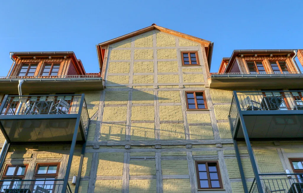 A timber-framed building facade with windows and projecting balconies.