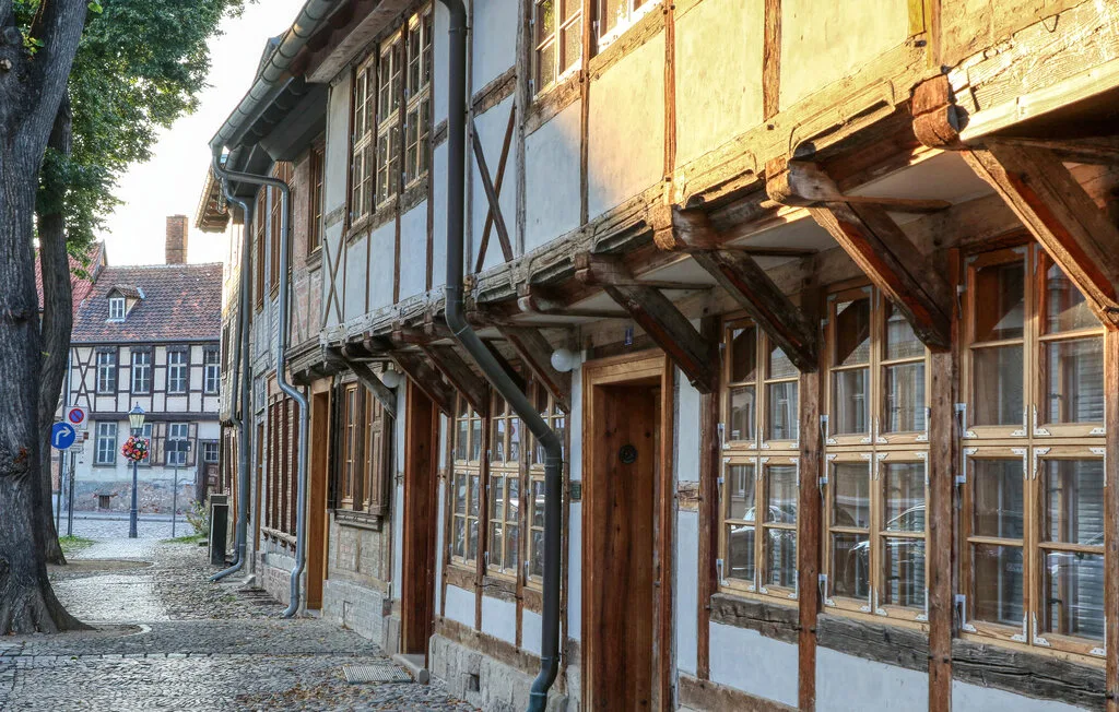 A cobblestone street lined with traditional timber-framed buildings.