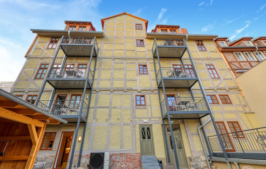 A multi-story building facade with balconies and rows of windows.