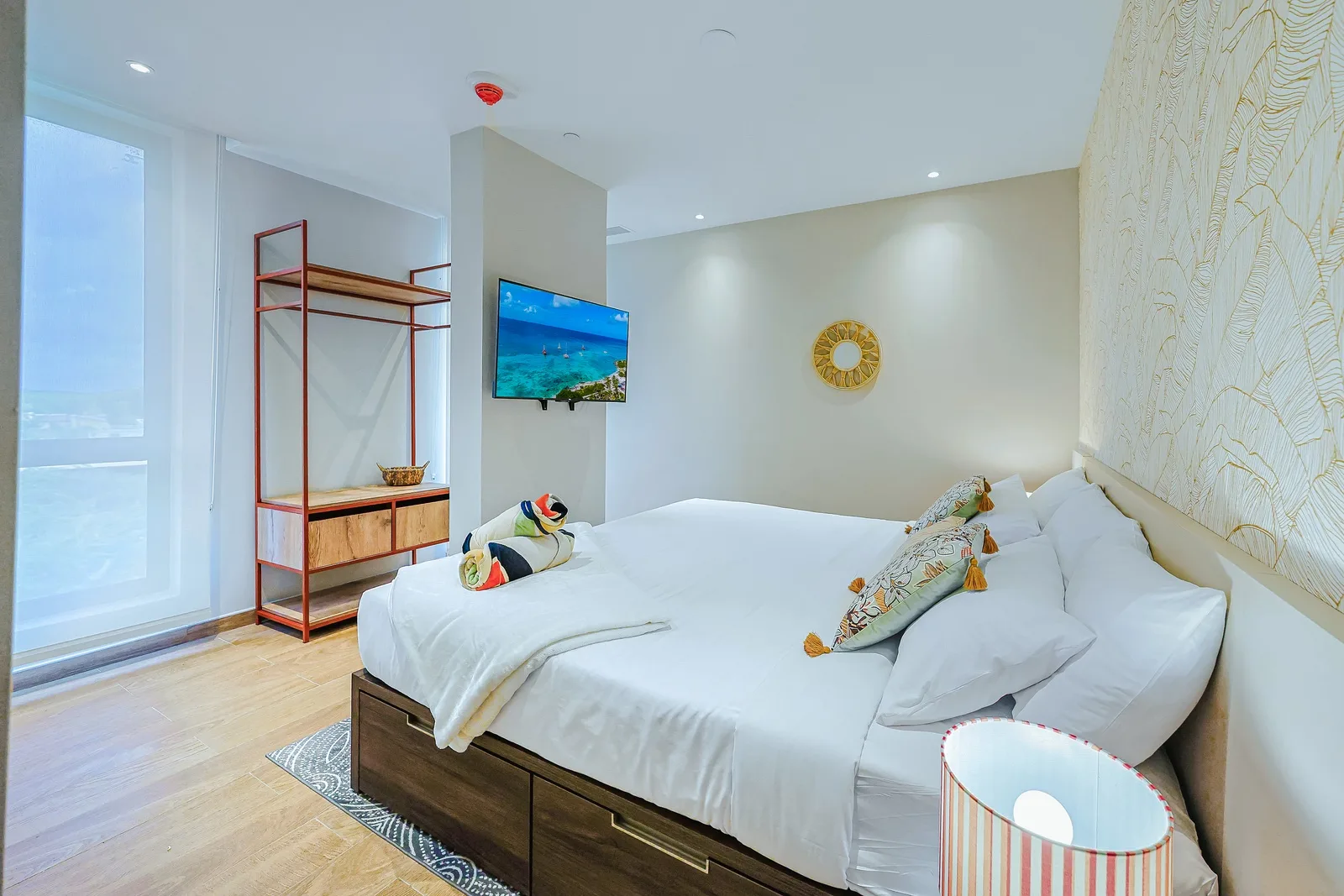 Unwind in a bright and thoughtfully designed bedroom featuring a plush king-size bed, modern furnishings, and a peaceful atmosphere for a restful night's sleep.
