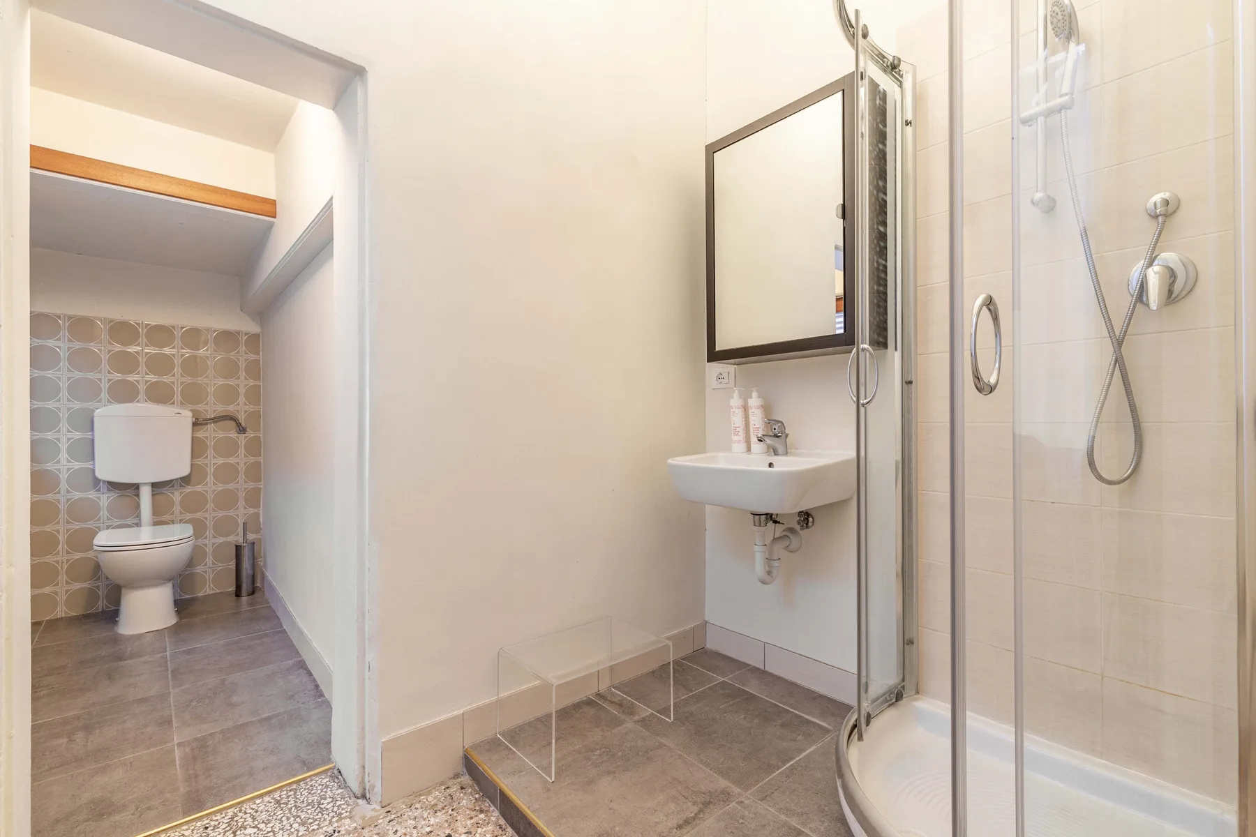 A bathroom with a sink and a glass shower.