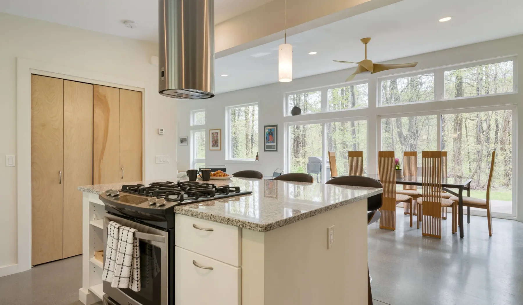 A bright open-plan kitchen and dining area with a large island and table.