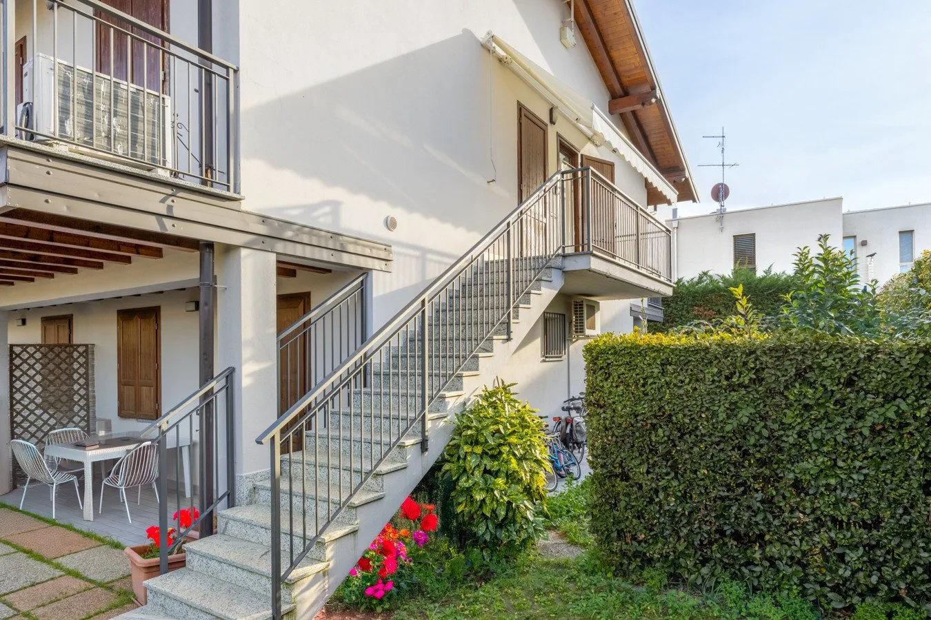 Exterior view of a building with an outdoor staircase and balconies.