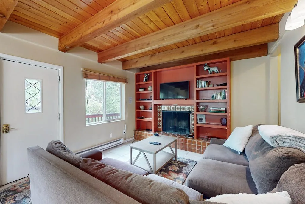 A living room with seating, a coffee table, and built-in shelving.