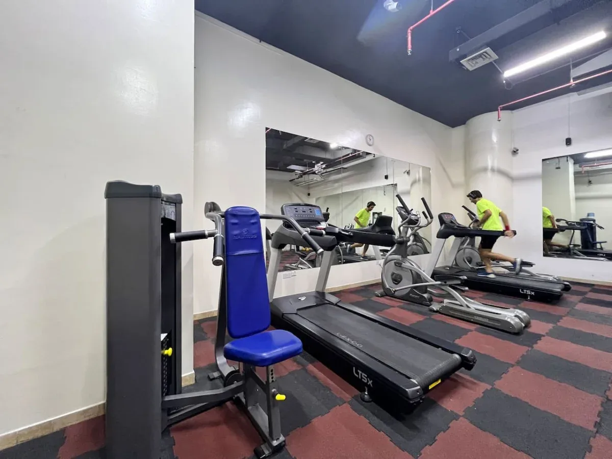A gym with treadmills and other exercise equipment.