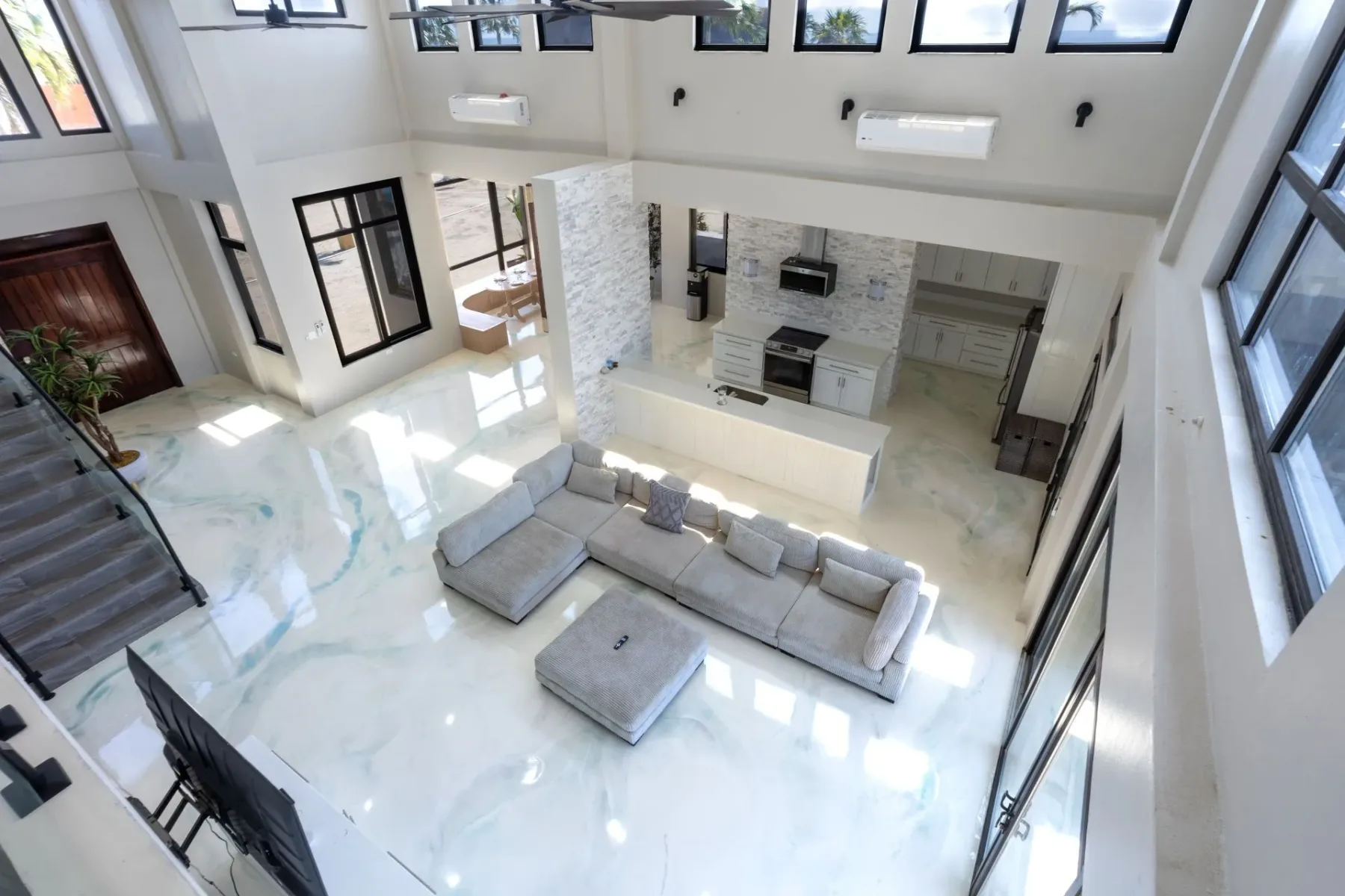 Living room with gray sofas and an open kitchen.