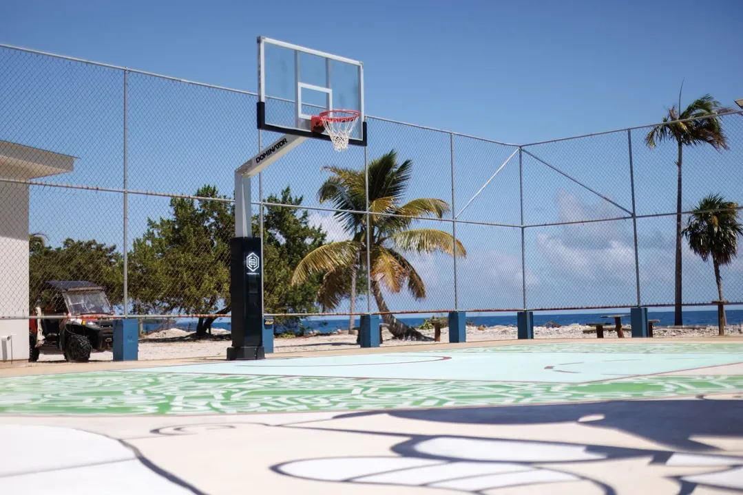 Outdoor basketball court beside the ocean.
