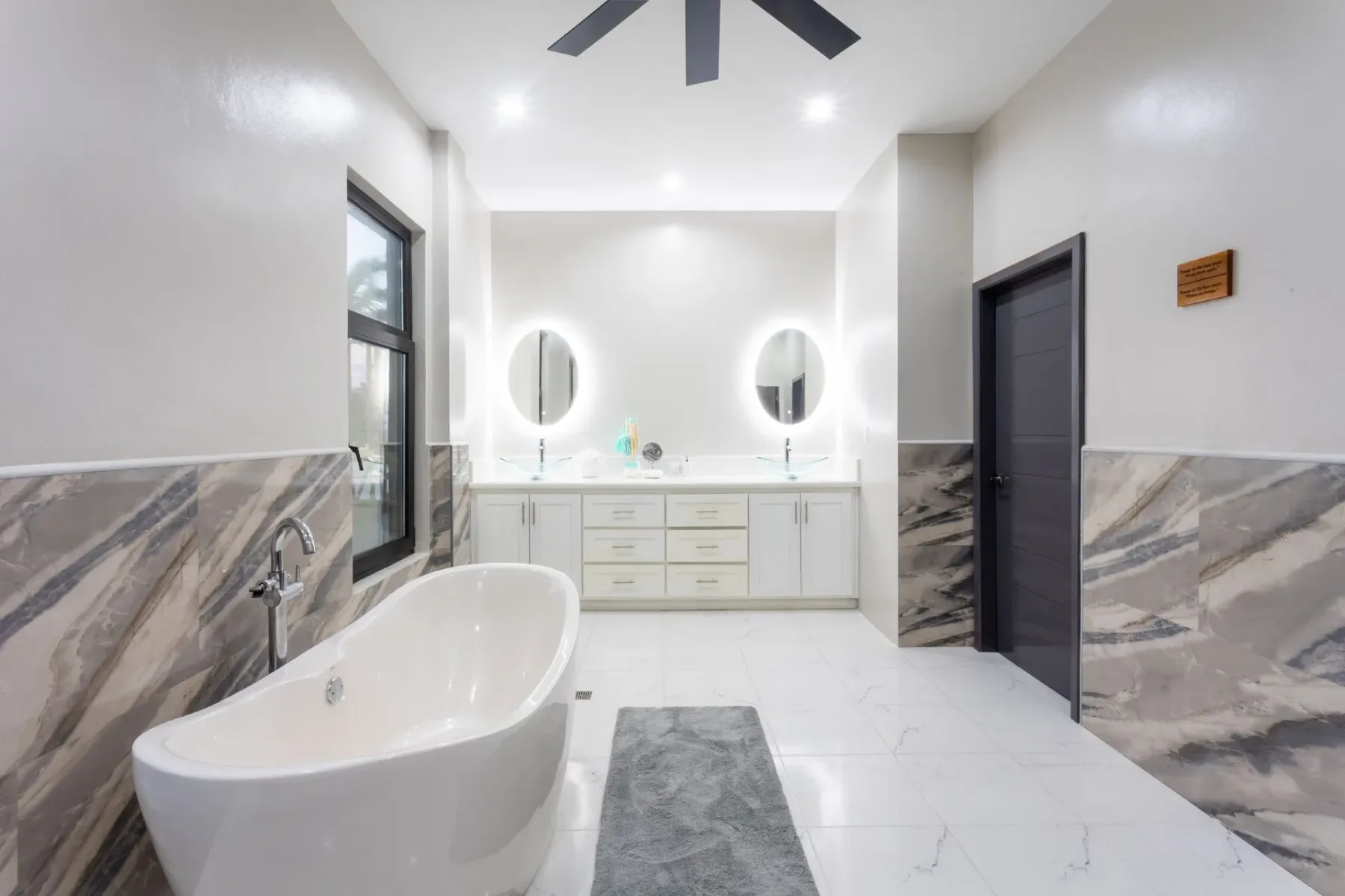 Bathroom with a freestanding tub and double vanity.