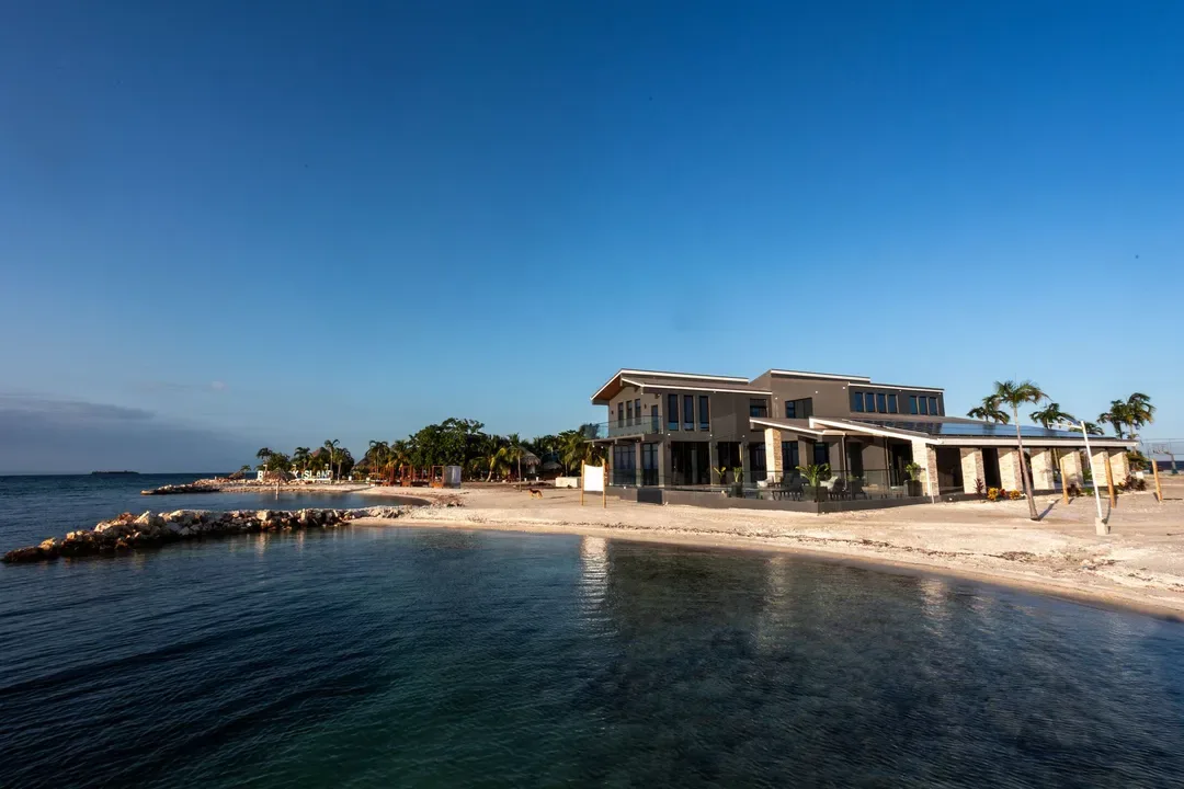 Seaside resort with a pier and calm blue water.