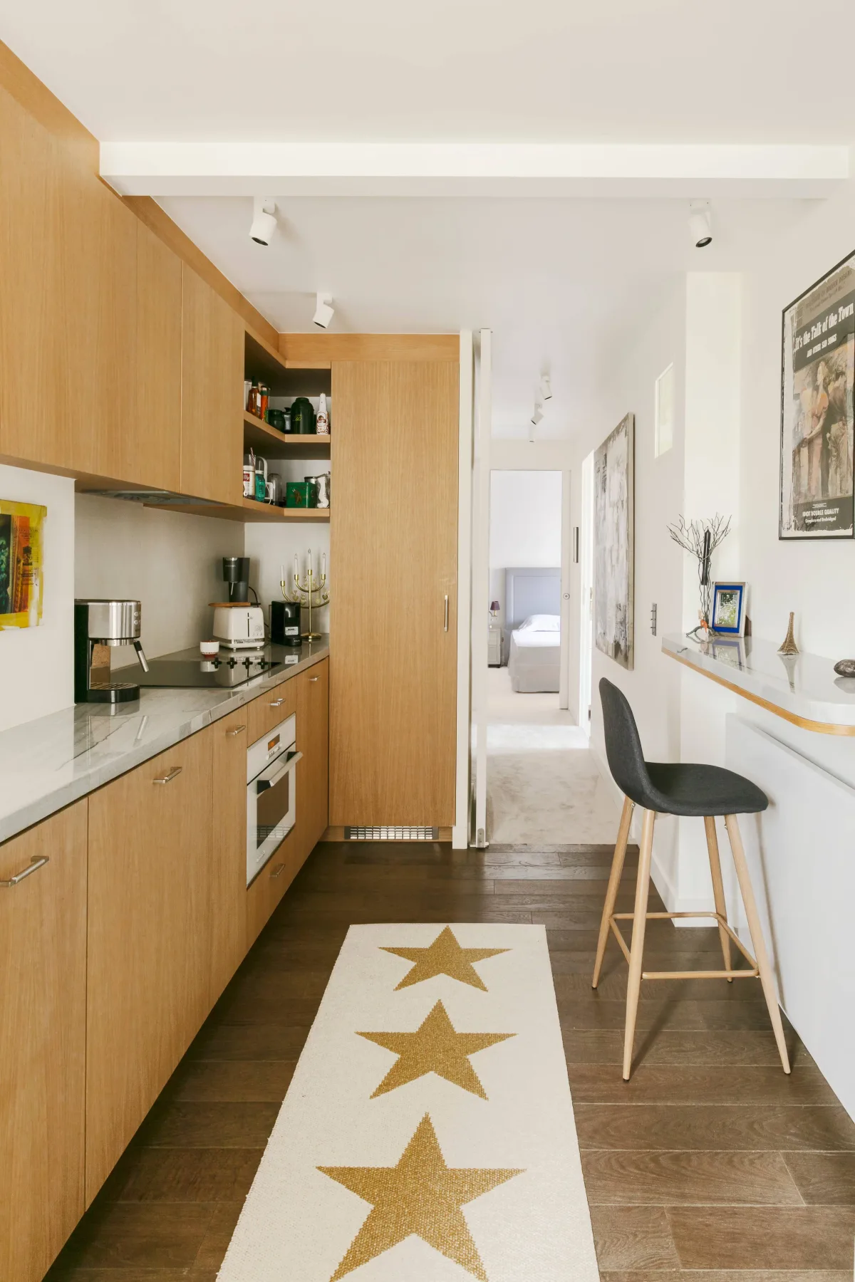 A compact kitchen with light wood cabinets and a counter.