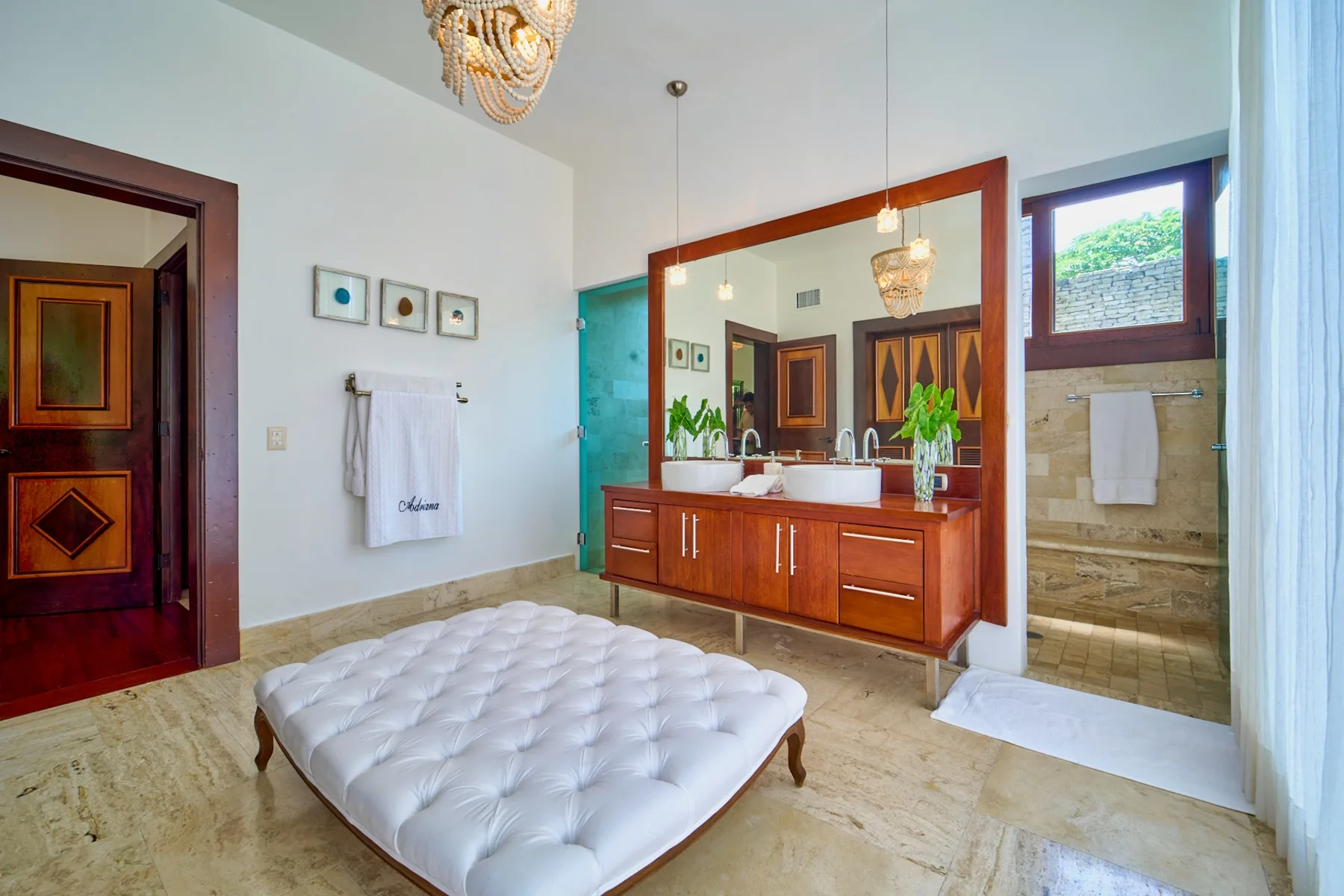 A bedroom with a low white mattress beside a wooden vanity and mirror.