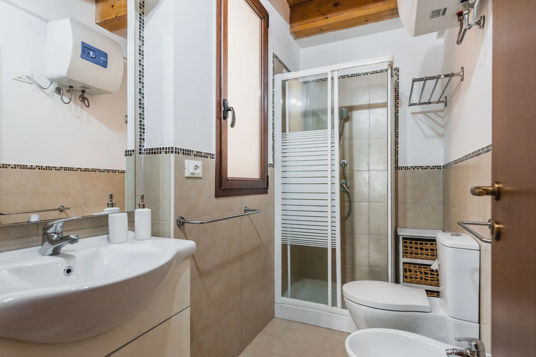Un baño con lavabo, inodoro y ducha de vidrio.