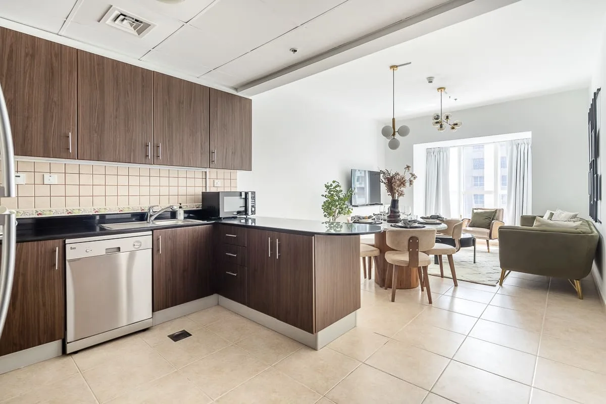 An open-plan kitchen and living area with a dining table beside the seating area.
