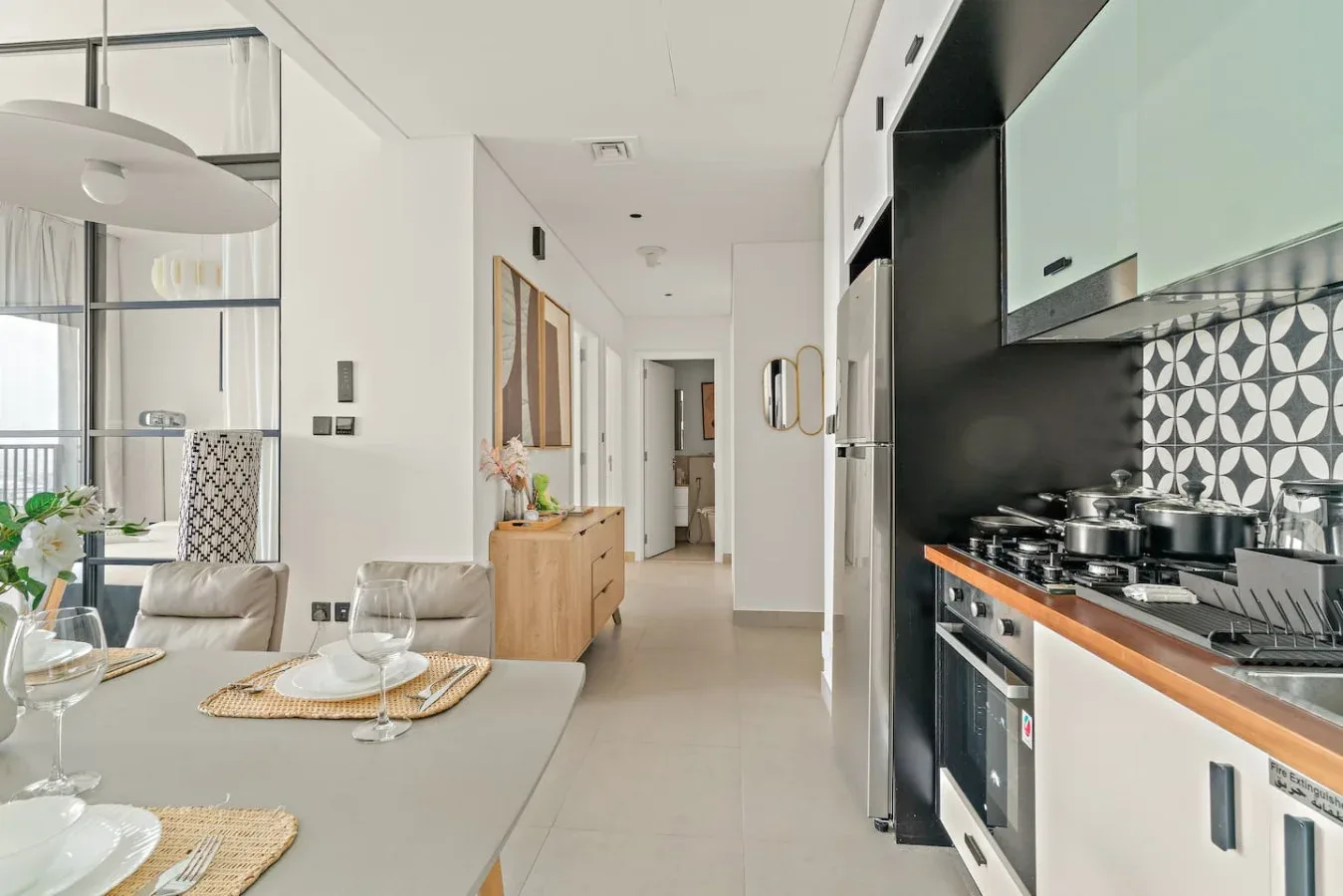 A bright open-plan kitchen and dining area with a long counter and dining table.