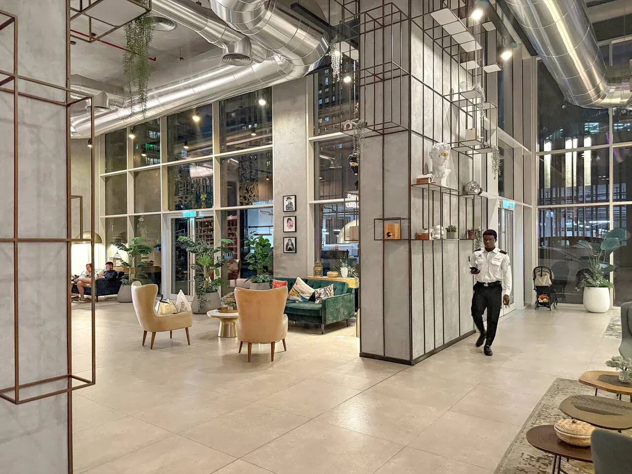 A spacious lobby with lounge seating and large windows.