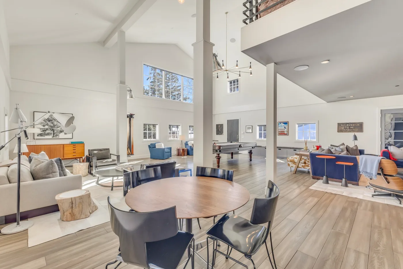Open-plan living and dining area with seating and a large table.