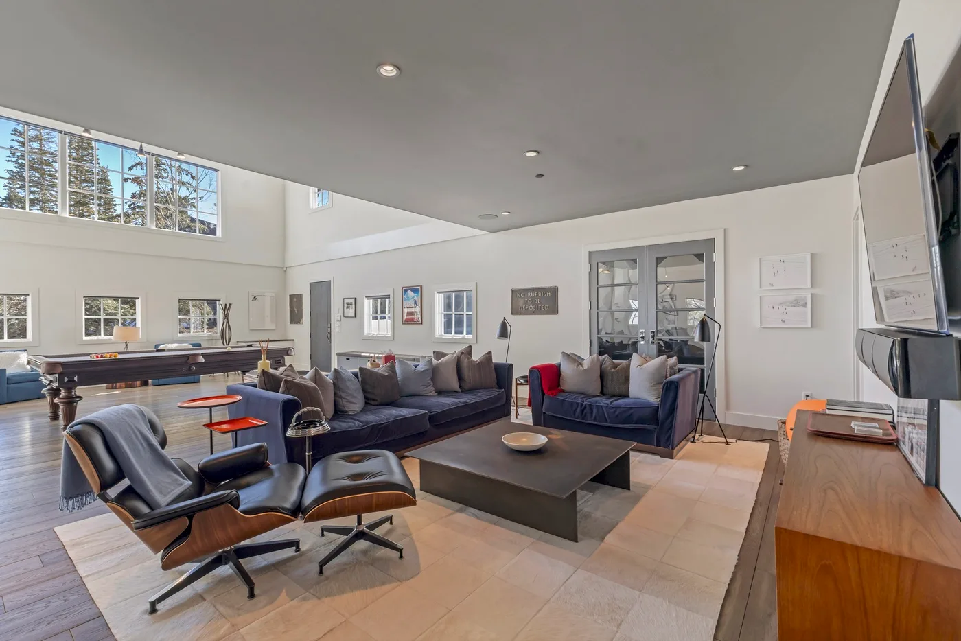 A bright living room with seating around a low coffee table.