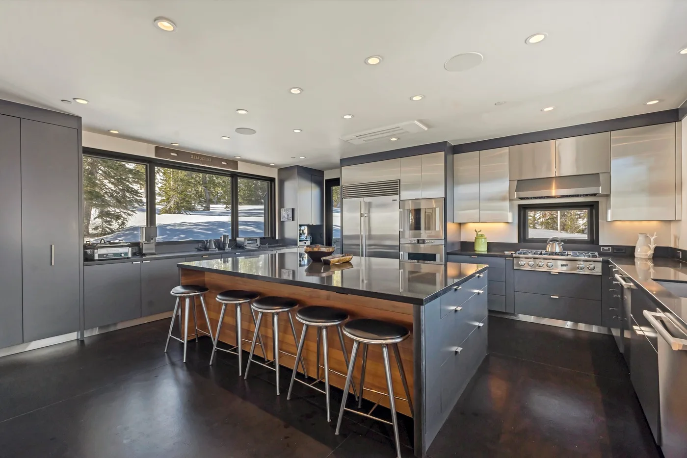 A modern kitchen with a large central island and bar seating.