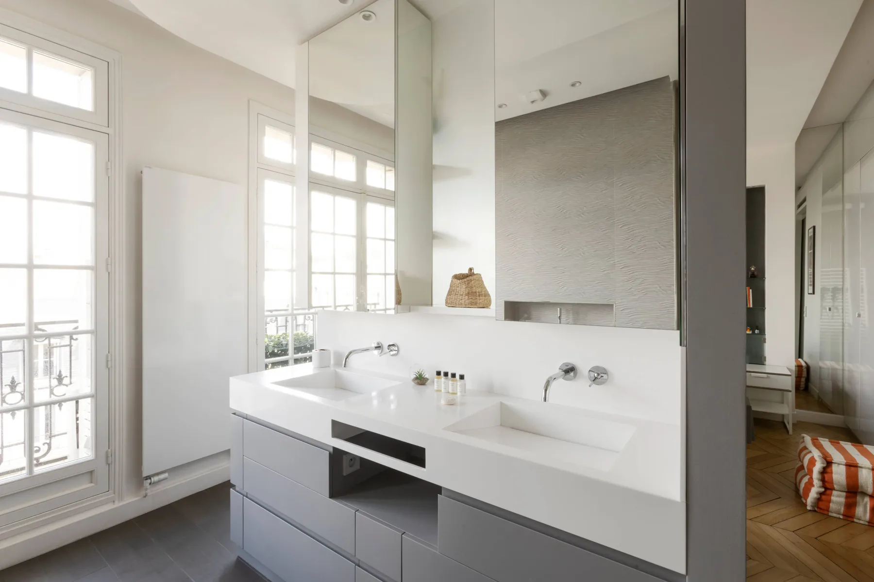 A bright bathroom with a wide double sink and large mirror.