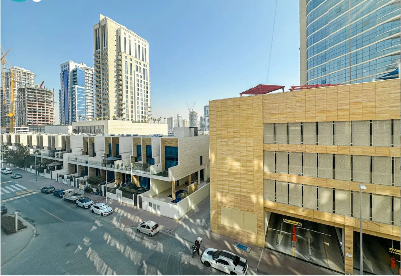 A city street lined with modern buildings and high-rise towers.