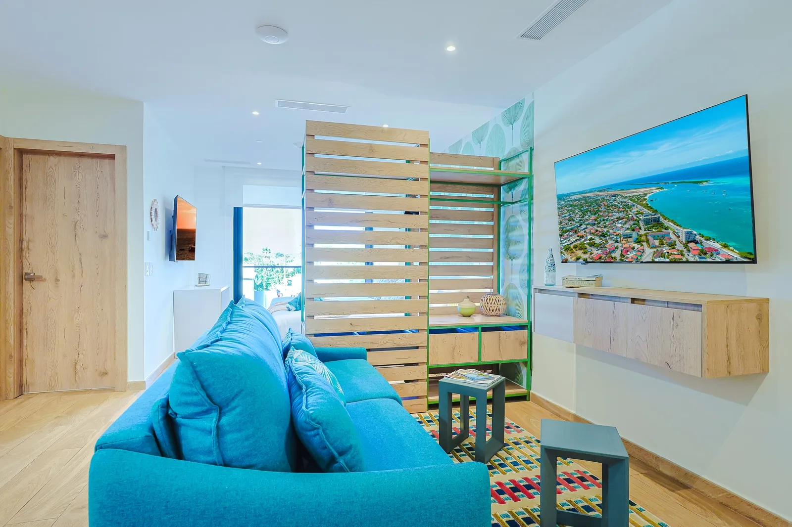 Relax in your bright, open living space with a comfy turquoise sofa, large TV