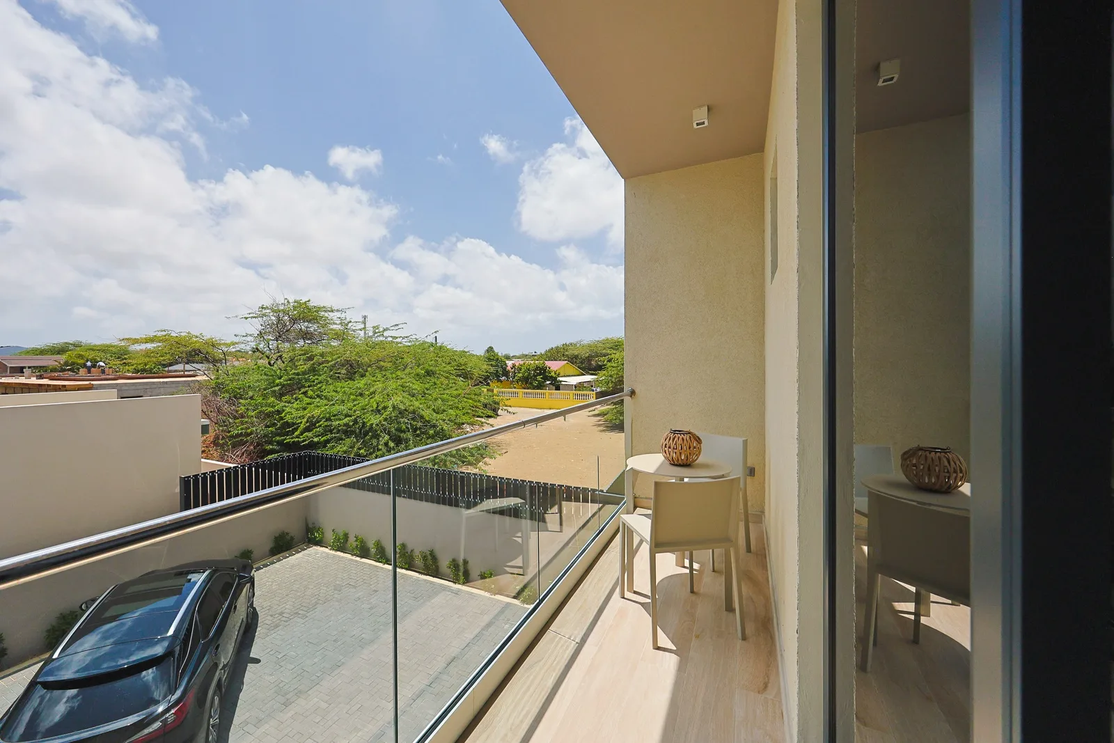 Your private balcony overlooks a quiet neighborhood dotted with lush greenery