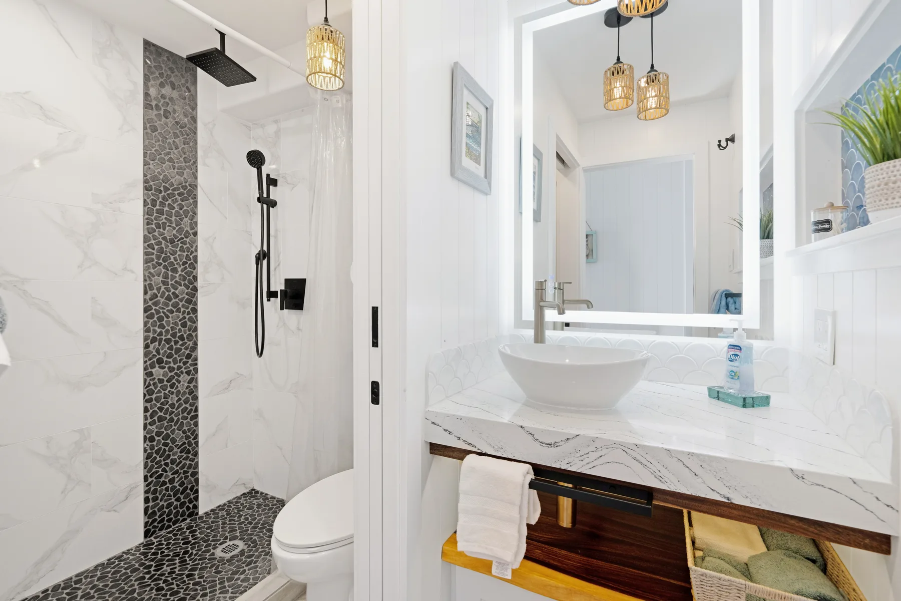 A bright bathroom with a glass shower and a vanity with a vessel sink.