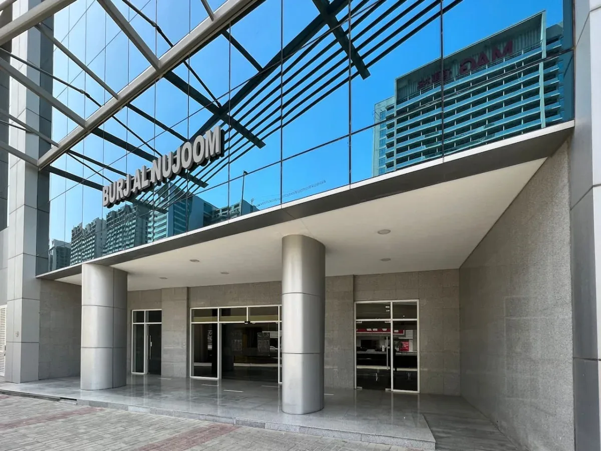 A modern building entrance with glass walls and metal columns.
